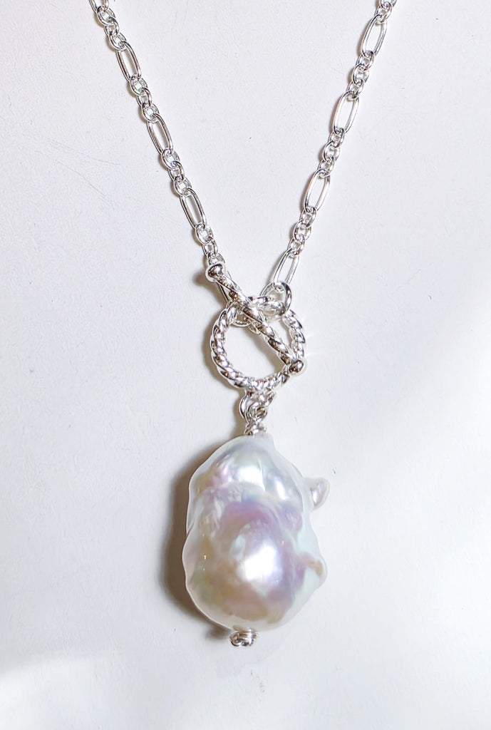 Elegant white freshwater baroque pearl choker necklace with sterling silver and a stylish front toggle clasp. A timeless and sophisticated statement piece.
