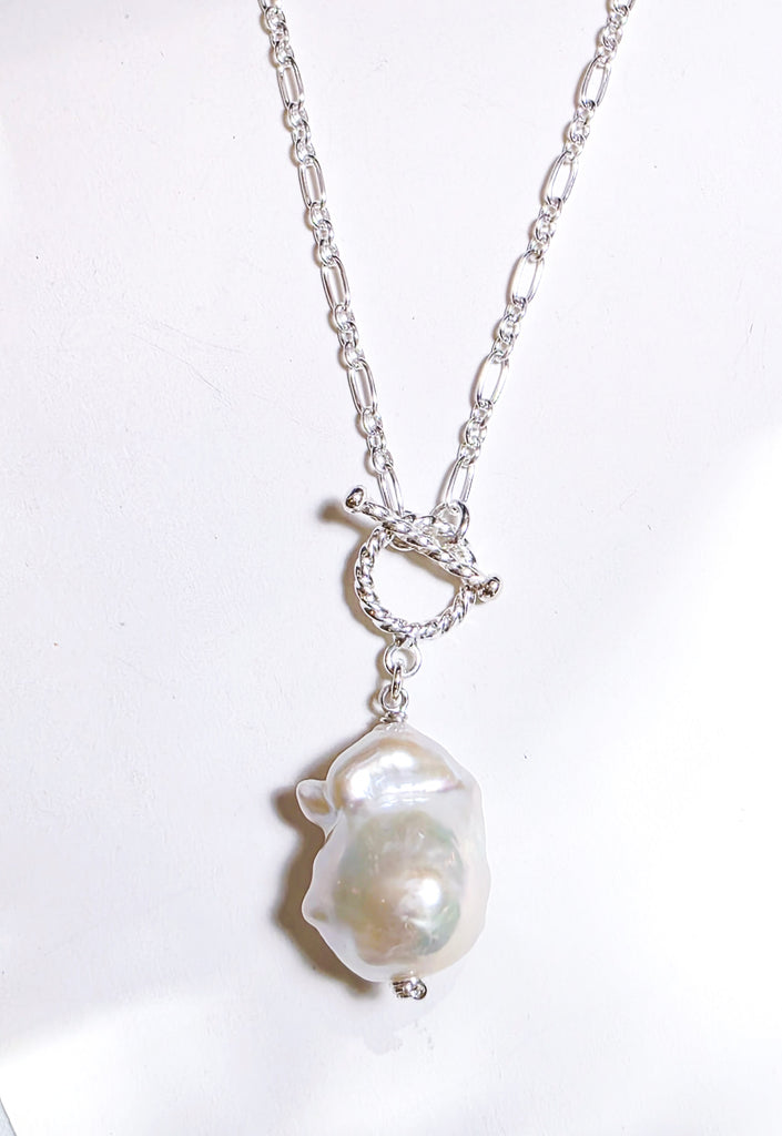 Elegant white freshwater baroque pearl choker necklace with sterling silver and a stylish front toggle clasp. A timeless and sophisticated statement piece.