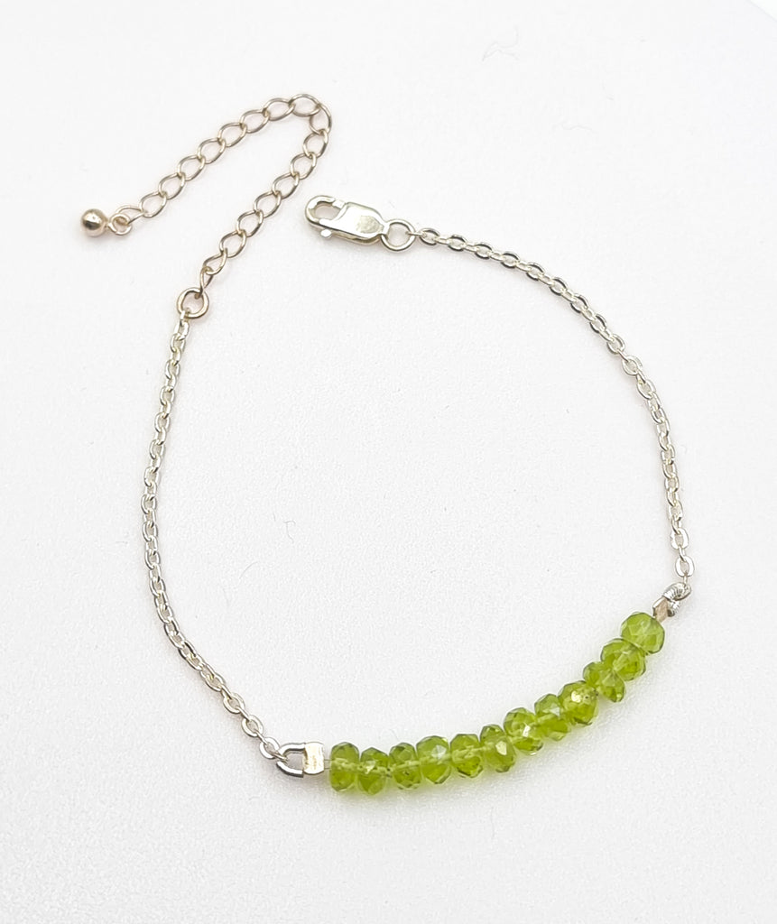 A luxuriously elegant Peridot bracelet for women, hand-crafted on sterling silver chain and adorned with high grade natural faceted Peridot gemstones, giving the bracelet a simple yet unique and sophisticated look. Renowned for their captivating green hue and August birthstone charm, this Peridot bracelet exudes a refreshing and sophisticated aura. 
