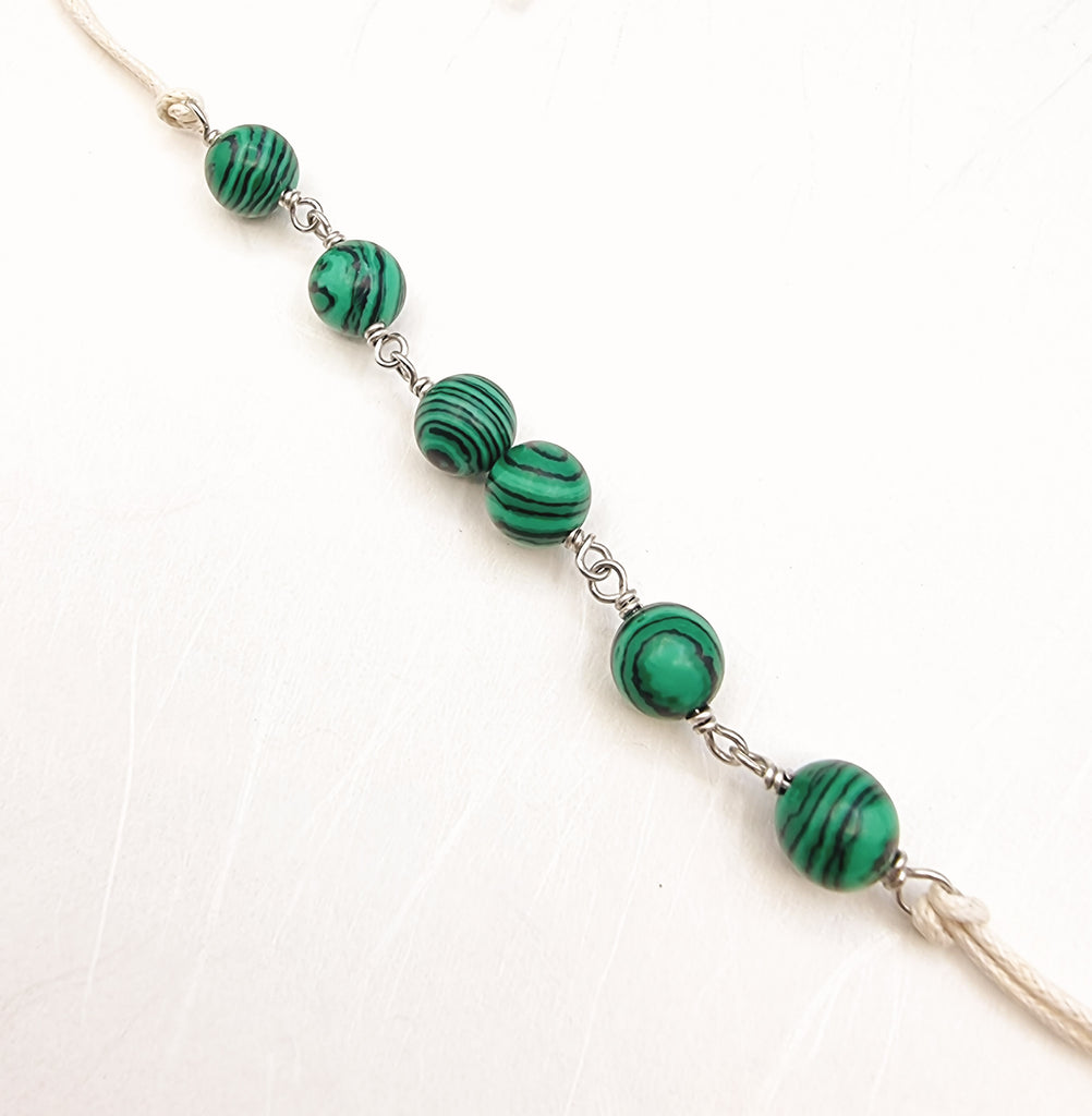 A handmade Rakhi delicately crafted with beautiful synthetic Malachite in a vivid hue of green. The colour green represents hope and optimism, harmony and balance. Truly unique and one-of-a-kind!