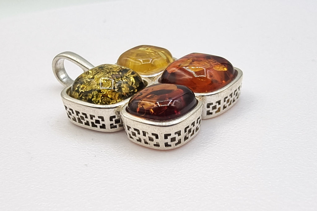 Discover our Art Deco-inspired natural Baltic amber pendant, meticulously crafted in sterling silver with four tones of amber. With stunning hues and a beautifully designed Art Deco-style bezel, this pendant is a timeless statement of elegance.