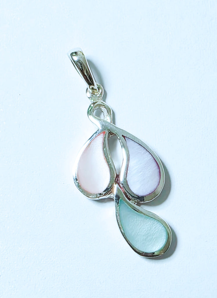 Elegant mother of pearl inlay pendant with enamel backing on sterling silver. A timeless, handcrafted piece that adds subtle luxury and charm to any look.