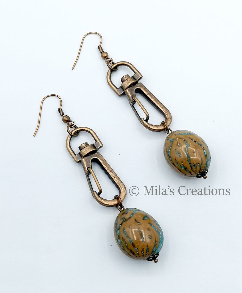 A pair of bag hooks transformed into fashionable earrings! With interchangeable beads - resin coated Peach Pit, Smoky Quartz, Hand blown glass beads, Swirl Shell beads, Lava Rock, Swarovski Pearls, these earrings make a fashion statement