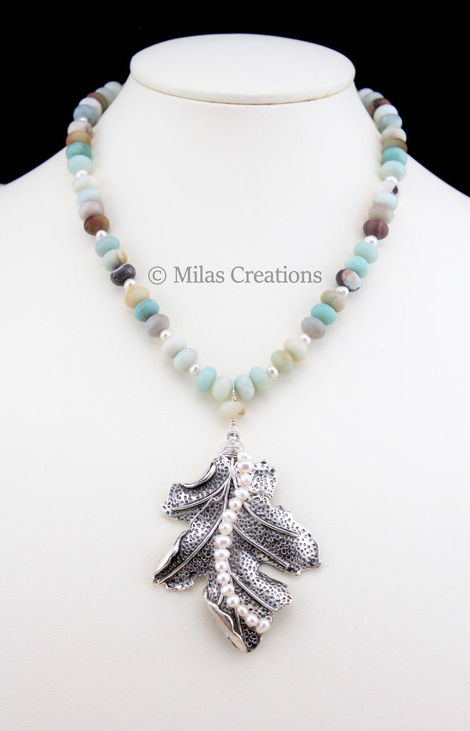 A handmade choker length necklace designed with beautiful graduating colours of Amazonite. An accent  German Silver leaf with Freshwater Pearl swirl adds a touch of elegance to this exquisite necklace
