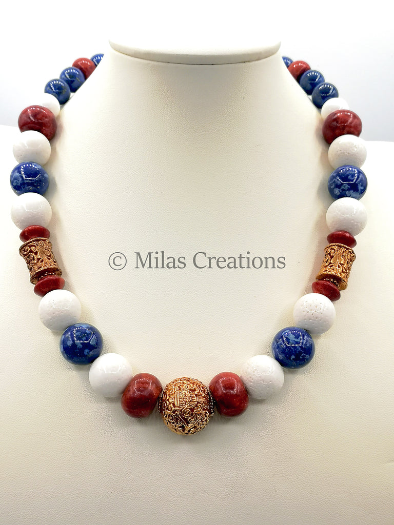 Choker length handmade Necklace designed with beautiful bold white Corals combined with an array of red Sponge Corals and Lapis Lazuli, with highlights of gold-plated beads. 